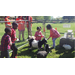 Youth enjoying baby goats and rabbits at the petting zoo.