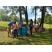 Volunteers and youth outside setting up for block party event. 