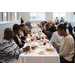 Residents gathered around multiple tables eating a Christmas meal.