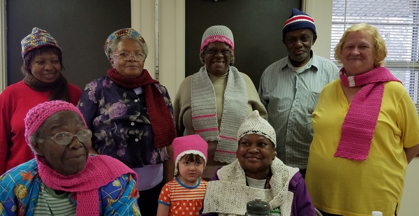 Senior Events Staff posing for pictures in knitted hats.
