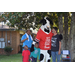 Chick-fil-a cow posing for picture with youth and adult National Night Out attendees.