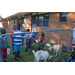 Youth residents peering over fence looking at baby petting zoo animals.