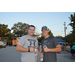 Two white men posing for picture showing thumbs up at National Night Out event.