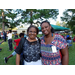 Two African American adult females smiling in picture taken at National Night Out event.