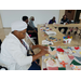 Seniors gathered around table organizing and designing their quilt pieces.