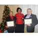 Commissioners Marguerite White and John Saidla holding certificates in loving memory of Clima White and Janice Saidla with CEO Sharon Tolbert. 