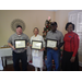 George Cannon, Beth Redding, and Timothy Wright holding their certificates and posing with CEO Sharon Tolbert recognizing their 5 year employee anniversary.