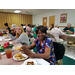 Senior Resident and a Auburn University Campus Kitchen student posing for picture at Christmas dinner.