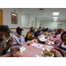Table of Auburn Housing Authority Senior Residents enjoying food and conversation courtesy of Auburn University's Campus Kitchen.