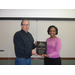 Lee Walters holding his retirement plaque with CEO Sharon Tolbert 