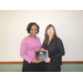 Shannon Walters holding her 15 year employee anniversary plaque with CEO Sharon Tolbert 