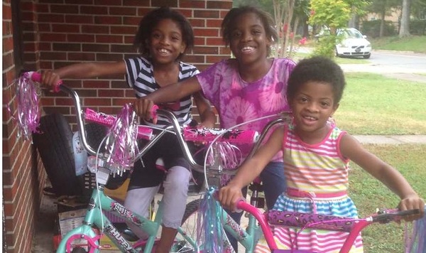 Bike giveaway recipients posing for a picture with their new bikes.