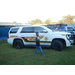 Kid walking in front of Lee County Sheriff Department vehicle