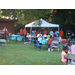 National Night Out yard view with tents, chairs, and crowd of people