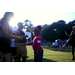 Girl reaching for a snake being held by an adult at National Night Out