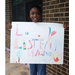 Andre Hogans Jr. holding her poster for Fire Prevention Week Poster Contest 