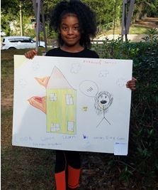 Florina Cristobal holding her poster for Fire Prevention Week Poster Contest 