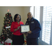 CEO Sharon Tolbert presenting employee Gregory Moore a 5 year anniversary plaque.