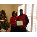 CEO Sharon Tolbert presenting employee a 5 year anniversary plaque.