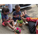 2 small kids painting clay flower pots