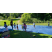 Summer day camp, kids playing on tarp with sprinkler