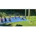 youth residents enjoying sprinkler activities on tarp outside