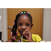 little girl smiling with fingers on straw