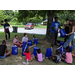 group of youth drumming on a bucket