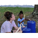 little girls drumming on a bucket