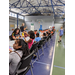 large group of kids seated at long folding tables