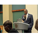 man in suit speaking from podium