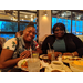 Two Resident Advisory Board members smiling over dinner table