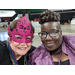 Resident Services Coordinator Charlotte Mattox and Resident Advisory Board Member smiling with masks and mardi-gras beads