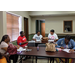 Family Self-Sufficiency program attendees talking and completing paperwork at table