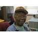 Older female resident smiling with hat on