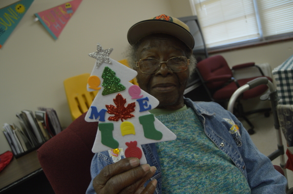 Female resident showing off her Christmas Tree craft