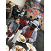 senior resident and young boy eating at luncheon