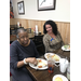 Senior resident and staff member eating and talking at holiday luncheon