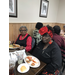 Senior residents at holiday luncheon table eating