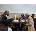 Male and two female residents eating at holiday luncheon