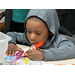 youth resident wearing a hoodie with marker drawing on paper