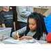 female youth resident with braids coloring with marker