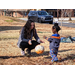 toddler giving Christmas tree ornament to volunteer