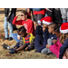 youth residents in santa hats sitting outside