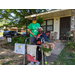 Senior resident in walkway with potted plants smiling