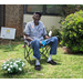 Senior resident sitting in lawn chair with beautiful potted plant
