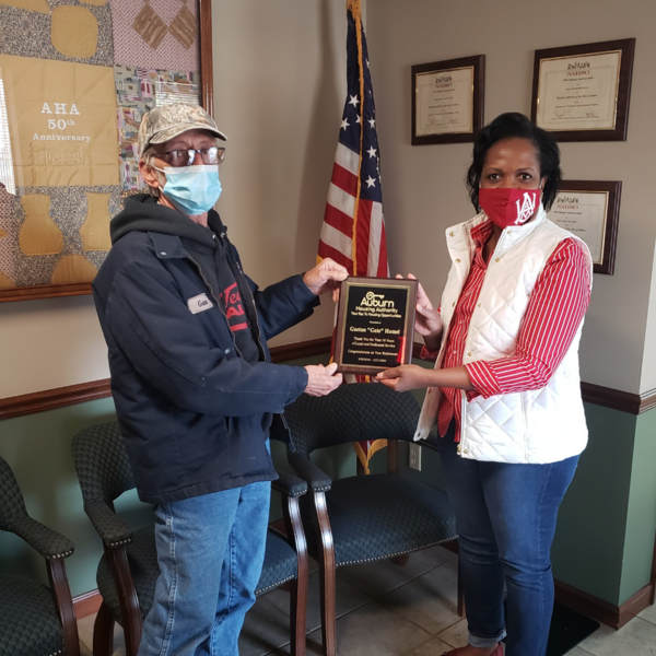 Gaetan Hamel holding 10 Year Anniversary and Retirement plaque with CEO Sharon Tolbert