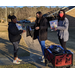 Female Student receiving school supplies from AHA Staff