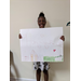 Youth holding up her What Home Means to Me poster drawing