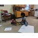 Youth residents sharing crayons on the floor with white poster